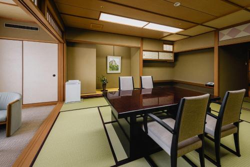 a conference room with a wooden table and chairs at Kinzan in Kobe