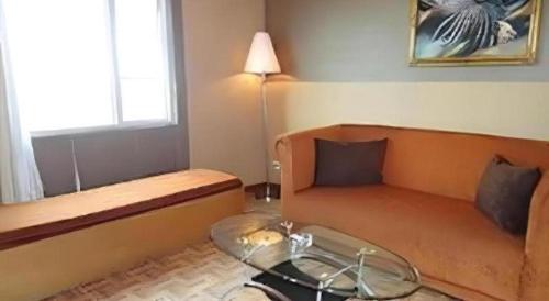 a living room with a couch and a table at Hotel Formosa in Manado