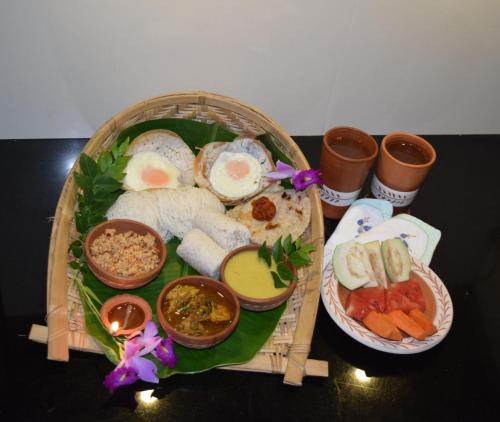 a tray of food with eggs and other foods on it at Muthu Nila villas- Mirissa in Mirissa