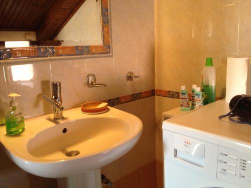 a bathroom with a sink and a mirror at Skala Fourkas Holiday Home in Skala Fourkas