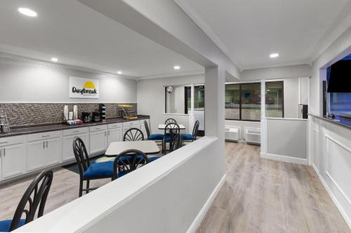 a kitchen and dining room with a table and chairs at Days Inn by Wyndham Temple in Temple