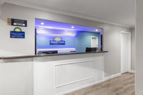 a large flat screen tv on a wall in a room at Days Inn by Wyndham Temple in Temple
