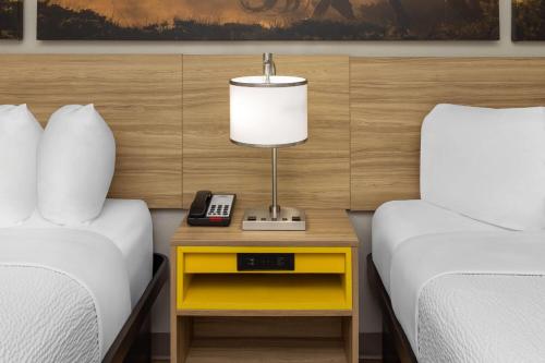 a bedroom with two beds and a lamp on a night stand at Days Inn by Wyndham Temple in Temple