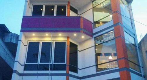 a tall building with a lot of windows at Hotel D' CaLia Tarakan in Tarakan