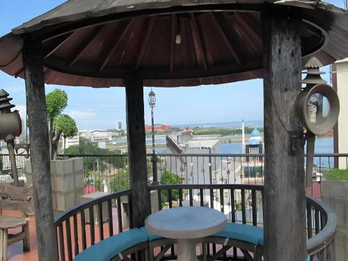 a table and an umbrella on a balcony at Kenari Tower Hotel in Makassar