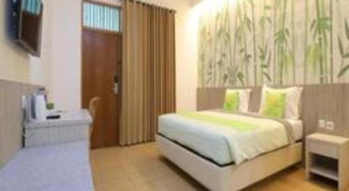 a bedroom with a bed and a sink in it at Hotel Huswah Airport in Jakarta
