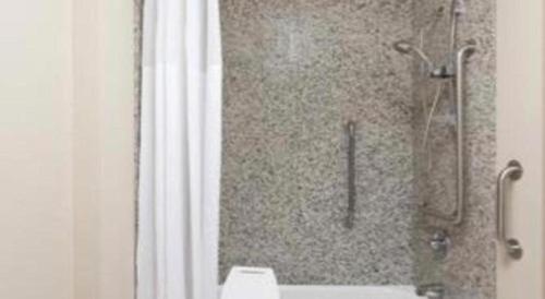 a shower in a bathroom with a shower curtain at Days Inn Springfield South in Springfield