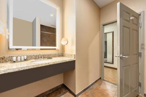 a bathroom with a sink and a mirror at La Quinta by Wyndham Marble Falls in Marble Falls