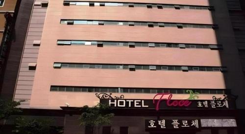 a tall building with a hotel sign in front of it at Hotel Floce in Bucheon