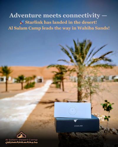 a laptop computer sitting on a rock in the desert at Al Salam Desert Camp Bidiya in Bidiyah