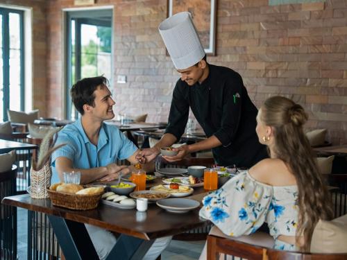 a chef preparing food at a table in a restaurant at Vallora Retreat Jawai Luxuria By Moustache in Bera