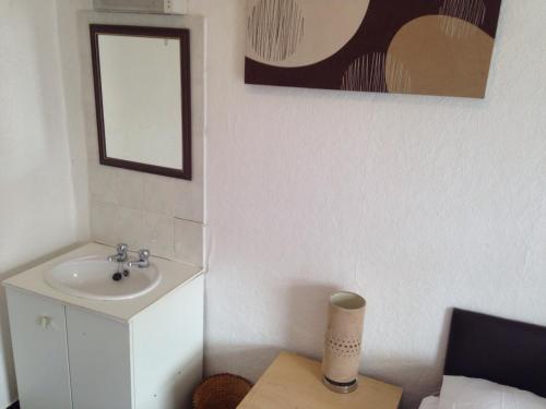 a bathroom with a sink and a mirror at The Driftwood Hotel in Blackpool