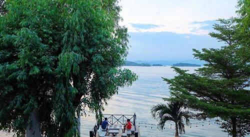 two people sitting on a boat in the water at Rim Kaeng resort in Phetchaburi