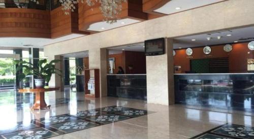a lobby of a building with a restaurant at Labersa Grand Hotel &Convention Center in Pekanbaru
