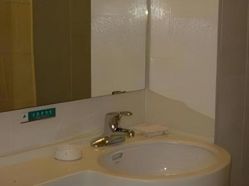 a bathroom sink with a mirror and a faucet at Jinjiang Inn Wuhu High-Speed Railway Station West Square in Wuhu