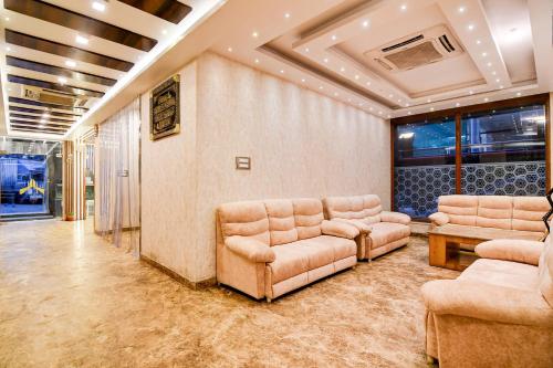a waiting room with couches and chairs in a building at FabHotel Aafreen International in Kolkata