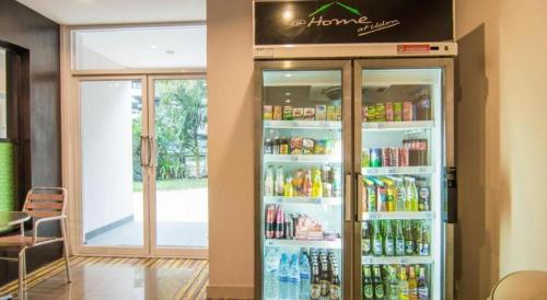 a refrigerator filled with lots of drinks in a restaurant at At Home at Udon in Udon Thani