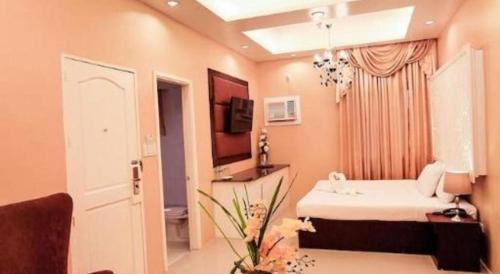 a bathroom with a white sink in a room at Islands Hotel in Roxas City