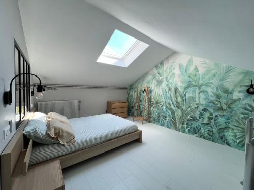 a bedroom with a bed and a skylight at Place de la gare cy in Commercy