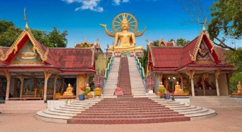 a large building with stairs leading up to a temple at Sea Suite Villa in Chaweng