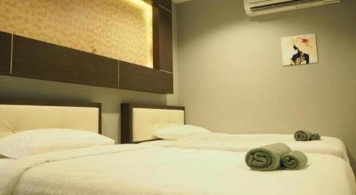 two beds in a bedroom with towels on them at Sea Suite Villa in Chaweng