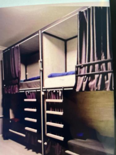 two bunk beds in a dorm room with stairs at Good driams Xoctel in Kyiv