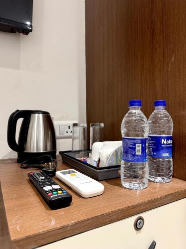 two bottles of water sitting on top of a counter at Hotel Eraya in Varanasi
