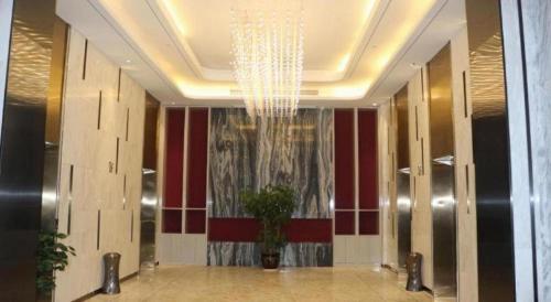 a lobby with a chandelier in a building at Taiyi International Hotel in Wenzhou