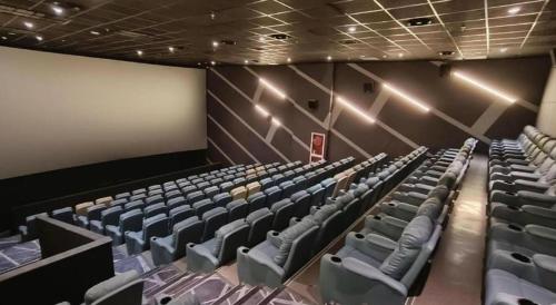 an empty auditorium with blue chairs in a theater at Taiyi International Hotel in Wenzhou
