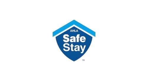 a blue sign that says mla safe stay at Comfort Inn & Suites University South in Ann Arbor