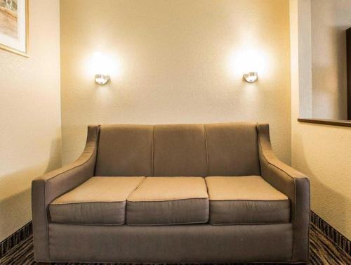 a couch sitting in a room with two lights at Quality Inn Dayton North - Vandalia in Dayton