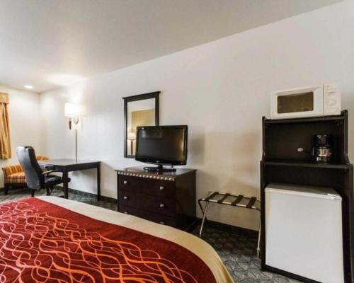 a hotel room with a bed and a desk at Quality Inn in Edgerton