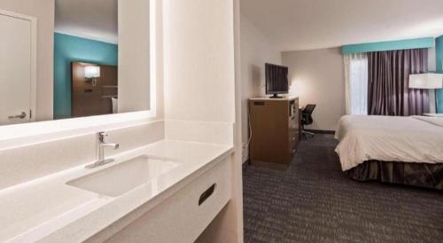 a bathroom with a sink and a bed in a hotel room at Best Western Galt Inn in Galt