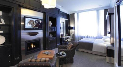 a hotel room with a bed and a fireplace at Fifteen Beacon Hotel in Boston