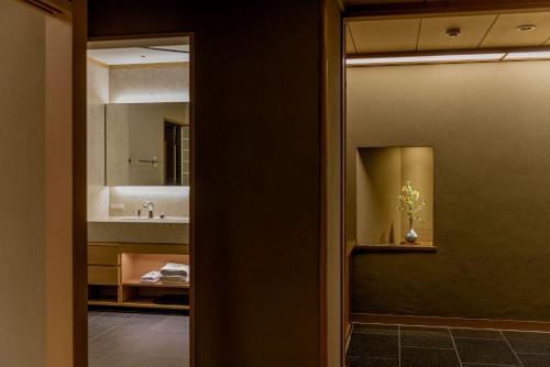 a bathroom with a sink and a mirror at Kinzan in Kobe