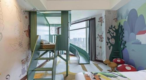 a childs bedroom with a bunk bed and a play area at New Century Grand Hotel Zhuji Yaojiang in Shaoxing