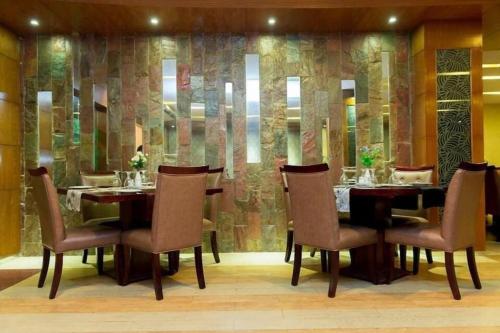 a dining room with a table and chairs at Hotel Tower Inn, Chittagong in Chittagong