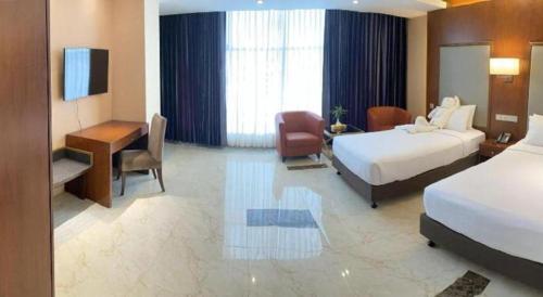 a hotel room with a bed and a desk at Hotel Tower Inn, Chittagong in Chittagong