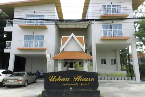 a sign in front of a white house at Urban House 195 in Chiang Mai