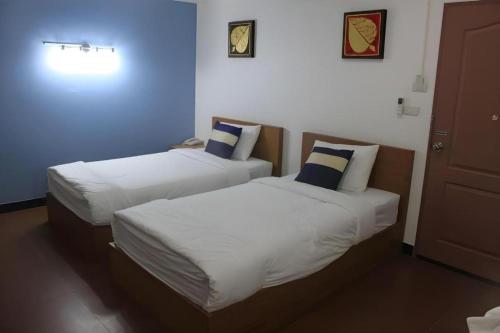 two beds in a room with blue and white at Urban House 195 in Chiang Mai