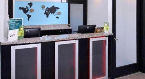 a black and white counter with two laptops on it at Econo Lodge Rochester I-90 & I-390 in Rochester