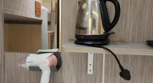 a blender on a shelf in a kitchen at New Mong Kok Guest House in Hong Kong