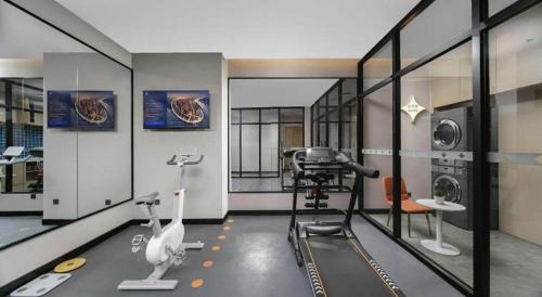 a room with a gym with a hair dryer and machines at Jinjiang Inn Changchun Xi An Avenue Branch in Changchun