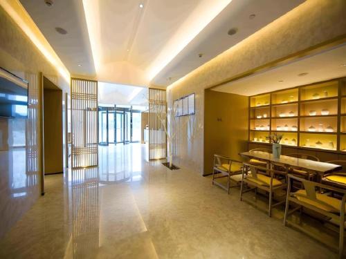 a dining room with a table and yellow chairs at Jinjiang Inn Select Kunming High-speed South Railway University Town in Kunming