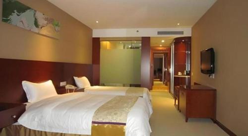 a bedroom with a large bed and a flat screen tv at Super 8 Hotel Quanzhou Xinchezhan Branch in Quanzhou