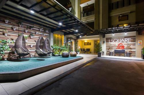 a room with a swimming pool in a building at L Square Hotel in Tarlac