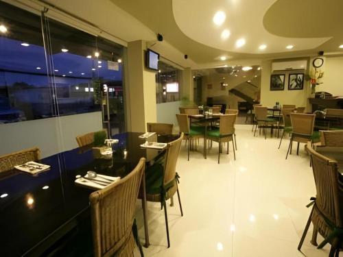 a dining room with tables and chairs in a restaurant at L Square Hotel in Tarlac