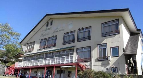 a large white building with windows on the side of it at Espoir Misawa in Hakuba