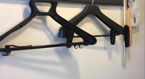 a black metal object is hanging on a wall at Alpha Hotel Tokushima in Tokushima