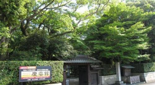 a bus stop with a sign in a park at Green Hotel Yes Nagahama Minatokan in Nagahama